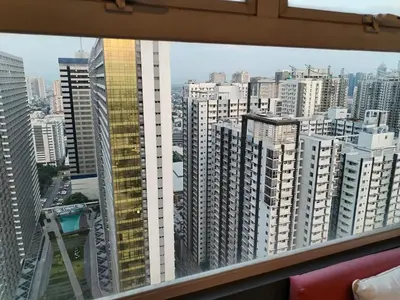 a view of a large city from a window at Affordable Studio 2 Twin Beds - City View EDSA in Manila