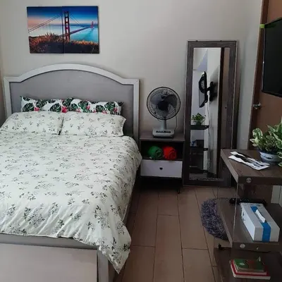 a bedroom with a bed and a mirror at LDN Secret Crib PALM TREE Across NAIA T3 in Manila