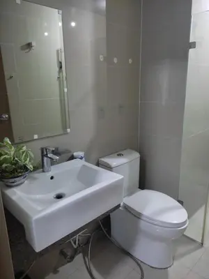 a bathroom with a white toilet and a sink at LDN Secret Crib PALM TREE Across NAIA T3 in Manila