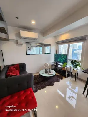 a living room with a couch and a table at Fort Victoria Tower B Condo BGC, Taguig City in Manila