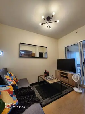 a living room with a couch and a flat screen tv at Torre de Manila Unit 1720 Taft Avenue Manila Unit 1720 in Manila