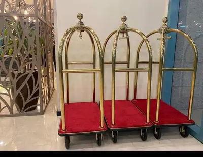 two metal and red luggage carts sitting in a room at BGC One Uptown Residence King Bed 3 min walk to malls and restaurants in Manila