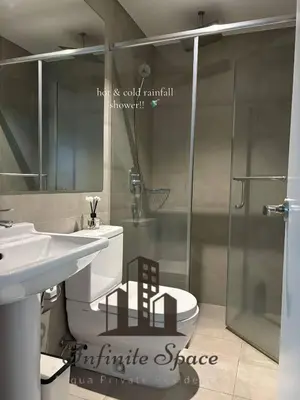 a bathroom with a sink and a toilet and a shower at Infinite Space at Acqua Private Residences - Iguazu Tower in Manila