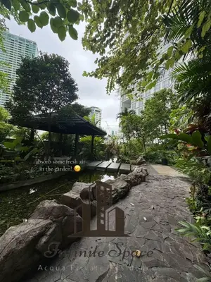a park with a bench and a pond with trees at Infinite Space at Acqua Private Residences - Iguazu Tower in Manila
