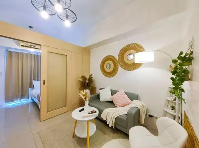 a living room with a couch and a table at 1BR Condotel with Balcony at SM Light Residences #LT02 in Manila