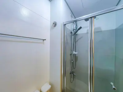 a bathroom with a shower with a glass door at 1BR Condotel with Balcony at SM Light Residences #LT02 in Manila