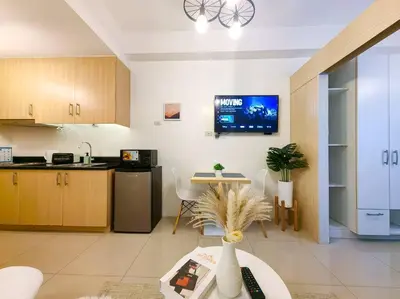 a living room with a kitchen and a table at 1BR Condotel with Balcony at SM Light Residences #LT02 in Manila