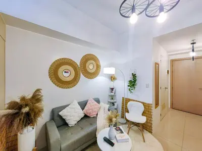 a living room with a couch and a chair at 1BR Condotel with Balcony at SM Light Residences #LT02 in Manila