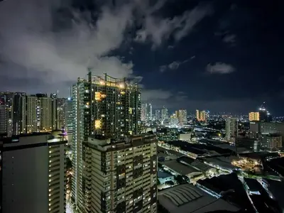 a view of a city at night at 1BR Condotel with Balcony at SM Light Residences #LT02 in Manila