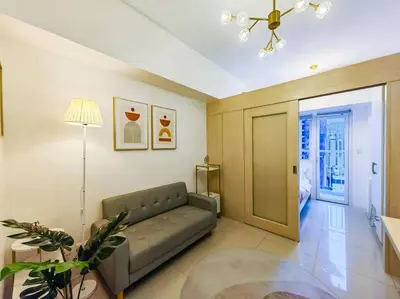 a living room with a couch and a table at 1BR Condotel with Balcony at SM Light Residences #LT03 in Manila