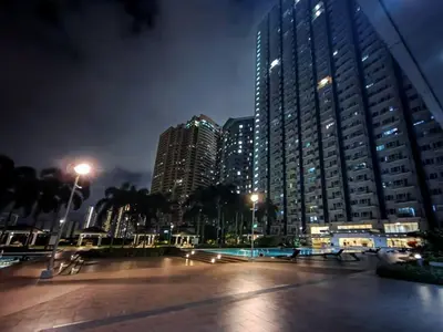 a city skyline with tall buildings at night at 1BR Condotel with Balcony at SM Light Residences #LT03 in Manila