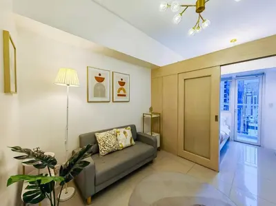 a living room with a couch and a table at 1BR Condotel with Balcony at SM Light Residences #LT03 in Manila