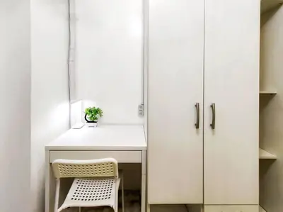a white kitchen with a desk and a chair at 1BR Condotel with Balcony at SM Light Residences #LT03 in Manila