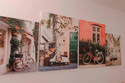 a group of three paintings of bikes on a wall at 1BR Condotel with Balcony at SM Light Residences #LT04 in Manila