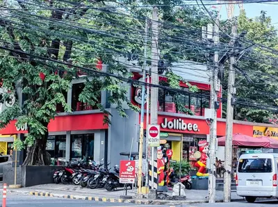 a street with motorcycles parked in front of a building at 1BR Condotel Suite at Sunshine100 City Plaza #SS07 in Manila