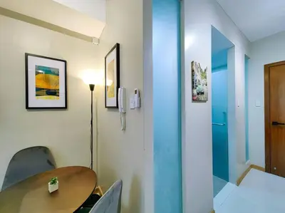 a room with a wooden table and chairs at 1BR Condotel Suite at Sunshine100 City Plaza #SS07 in Manila