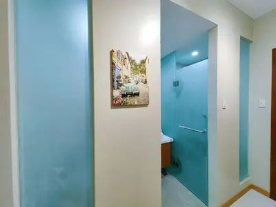 a bathroom with a blue door and a sink at 1BR Condotel Suite at Sunshine100 City Plaza #SS07 in Manila