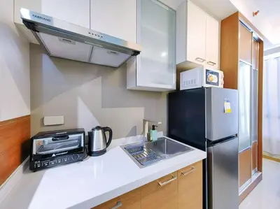 a kitchen with a sink and a refrigerator at 1BR Condotel Suite at Sunshine100 City Plaza #SS07 in Manila