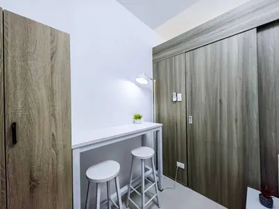 a kitchen with two stools and a bar in a room at 1BR Condotel with Balcony at FAME Residences #FM01 in Manila