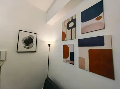 a room with some abstract paintings on the wall at 1BR Condotel with Balcony at FAME Residences #FM01 in Manila