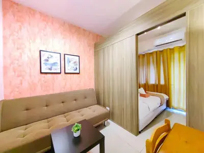a living room with a couch and a mirror at 1BR Condotel with Balcony at FAME Residences #FM02 in Manila