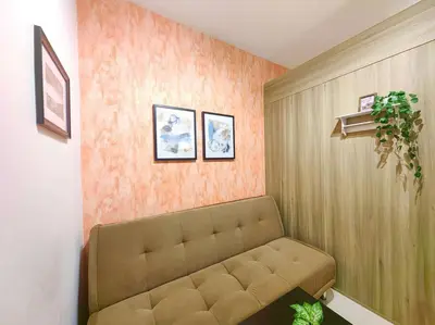 a living room with a couch in a room at 1BR Condotel with Balcony at FAME Residences #FM02 in Manila