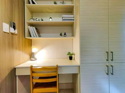 a room with a desk with a chair and a book shelf at 1BR Condotel with Balcony at FAME Residences #FM03 in Manila
