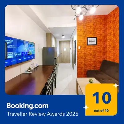 a living room with a couch and a tv at 1BR Condotel with Balcony at FAME Residences #FM04 in Manila