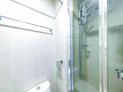a bathroom with a shower with a glass door at 1BR Condotel with Balcony at FAME Residences #FM04 in Manila