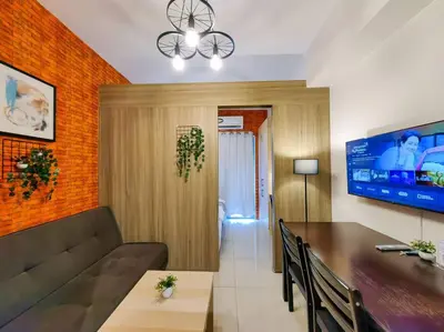 a living room with a couch and a table at 1BR Condotel with Balcony at FAME Residences #FM04 in Manila