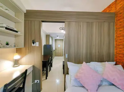 a bedroom with a bed and a desk and a dining room at 1BR Condotel with Balcony at FAME Residences #FM04 in Manila