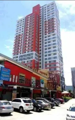 a parking lot with cars parked in front of tall buildings at Sunshine 100 Plaza - Bright and cozy 1 bedroom with washer in Manila