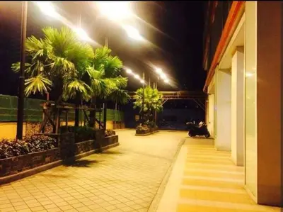 a cat sitting on the floor of a building at night at Sunshine 100 Plaza - Bright and cozy 1 bedroom with washer in Manila