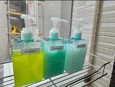 three bottles of water sitting on a rack at Sunshine 100 Plaza - Bright and cozy 1 bedroom with washer in Manila