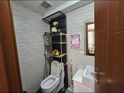 a bathroom with a toilet and a sink at Sunshine 100 Plaza - Bright and cozy 1 bedroom with washer in Manila