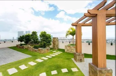a garden on the roof of a building with a pergola at Sunshine 100 Plaza - Bright and cozy 1 bedroom with washer in Manila