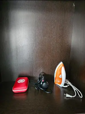 a table with a red phone and other items on it at Sunshine 100 Plaza - Bright and cozy 1 bedroom with washer in Manila