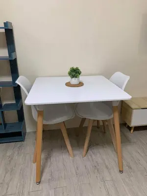 a white table with two chairs and a plant on it at Studio-type Apartment near Manila International Airport in Manila