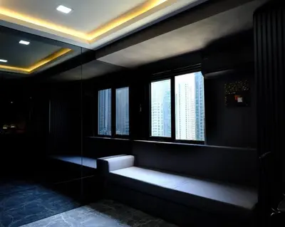 a dark room with a bench in front of windows at Casa Rica for adventurous fun - C Fort TB in Manila