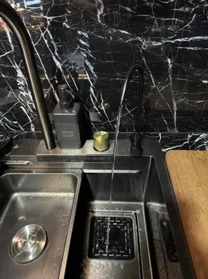 a kitchen sink with two faucets on top of it at Casa Rica for adventurous fun - C Fort TB in Manila