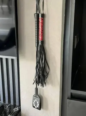 a whisk hanging on a wall next to a door at Casa Rica for adventurous fun - C Fort TB in Manila