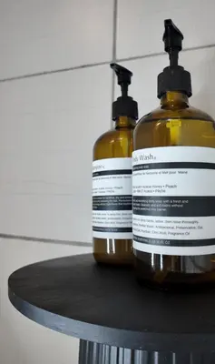 two bottles of soap sitting on top of a table at NITO Modern Philippine Styled Home at Jazz Residences Makati in Manila