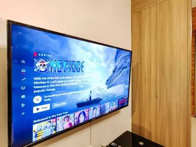 a flat screen tv hanging on a wall at 1BR Condotel with Balcony at FAME Residences #FM05 in Manila