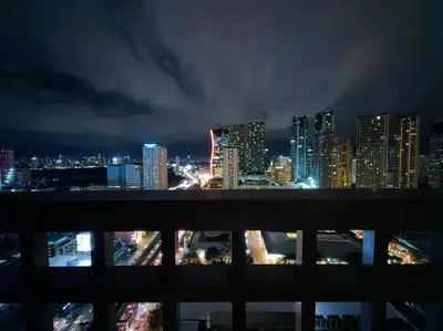 a view of a city skyline at night at 1BR Condotel with Balcony at FAME Residences #FM05 in Manila