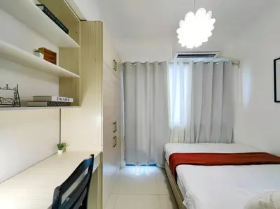 a small bedroom with a bed and a window at 1BR Condotel with Balcony at FAME Residences #FM07 in Manila