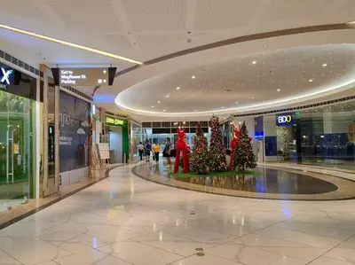 a shopping mall with christmas trees in the middle at 1BR Condotel with Balcony at FAME Residences #FM07 in Manila