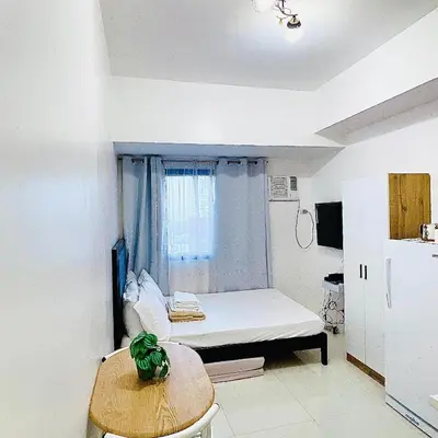 a small room with a bed and a window at Serene Condo Unit in Front of US Embassy in Manila