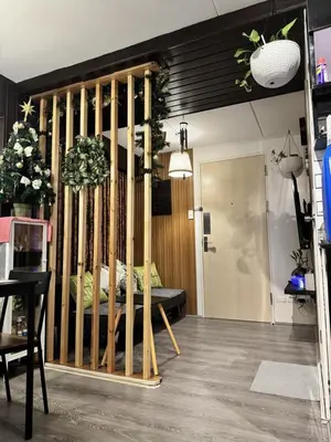 a room with a bed with bamboo poles at Deca Suites 946 in Manila