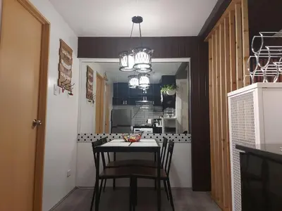 a dining room with a table and chairs in a kitchen at Deca Suites 946 in Manila