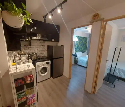 a kitchen with a stove and a washing machine at Deca Suites 946 in Manila